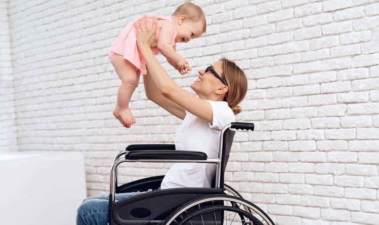 mother wheelchair play with newborn baby 01